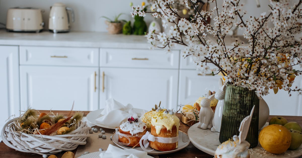 Elegant Easter table setup with cakes and blooming branches in a modern kitchen.