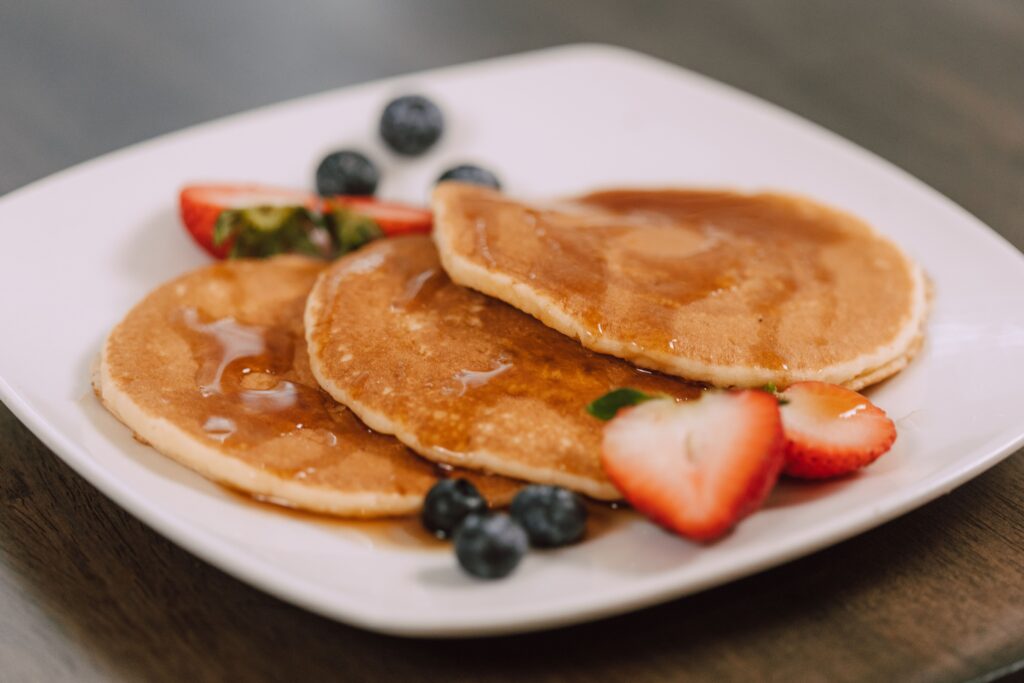 pexels-photo-6529790-6529790 Mouth-watering pancakes topped with syrup and fresh berries, perfect for a wholesome breakfast.